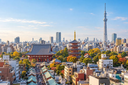 Elevated view of Tokyo’s Senso-ji temple roofs with the Skytree in a bright blue skyline