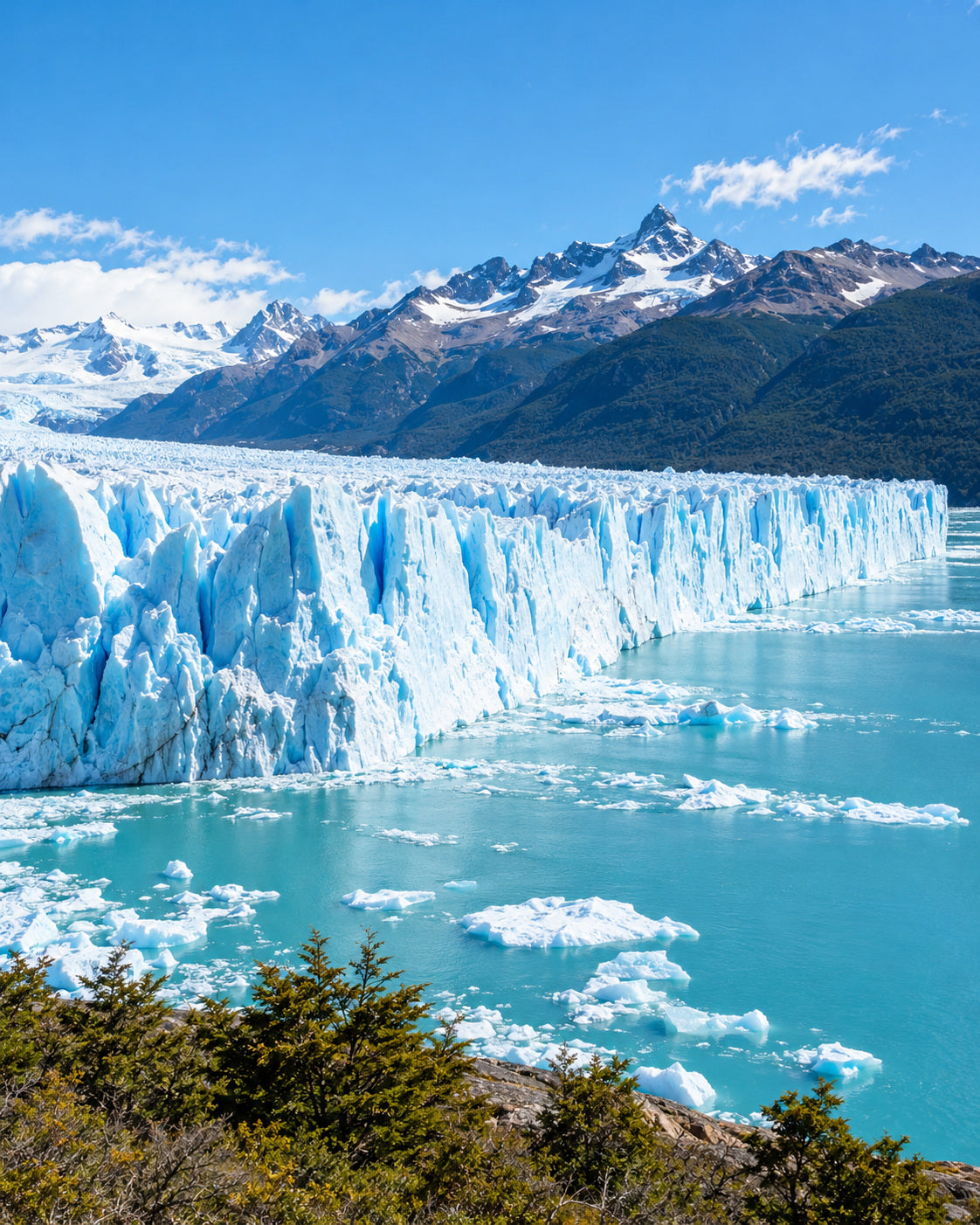 El Calafate: perito Moreno Glacier's blue-white ice wall meeting turquoise Lago Argentino beneath distant mountains and clear sky